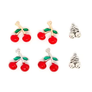 Close-up detail of cute red and silver cherry charms for DIY jewelry making and crafting.