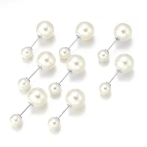 Detailed close-up view of off-white faux pearl brooch pins, perfect for DIY jewelry making.