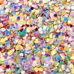Détail macro de paillettes en PVC en forme de cœur holographiques colorées pour le nail art.