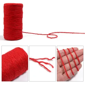 Red jute twine detail shot showing fiber texture and hand scale for craft and gift wrapping.