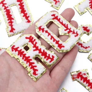 Detailed close-up of chenille letter patches featuring baseball stitch and gold glitter edges.