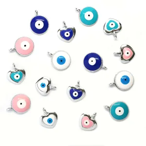 Detailed view of assorted Turkish evil eye charms in round and heart shapes for DIY jewelry making.