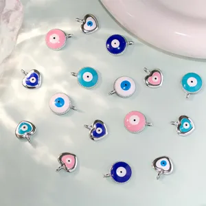 Close-up of DIY evil eye and heart charms pendant accessories for bracelet making.