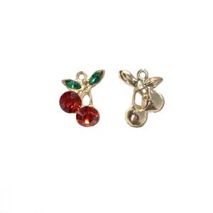 Close-up detail shot of red and green rhinestone cherry alloy DIY jewelry pendant accessories.