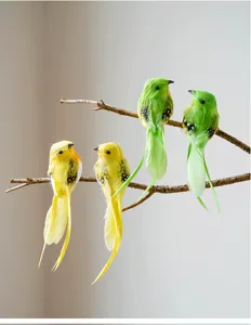 Detailed view of artificial colorful feather birds perched on natural tree branches closeup.