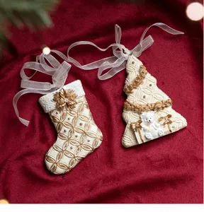 Resin Christmas tree and sock hanging ornament detailed view in white and gold finish.