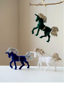Detail view of lovely velvet unicorn ornaments with sequin manes, perfect for Christmas decor.