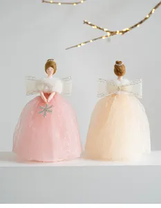 Detailed view of Christmas angel tree topper dolls with pink and beige lace dresses.