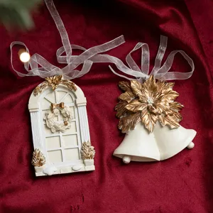 Christmas resin ornament detail view, white and gold bells and window design, festive decor.