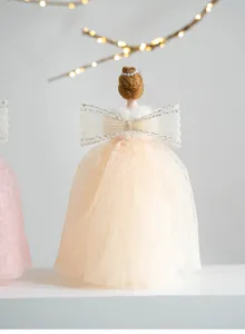 Closeup detail of the elegant beige Christmas tree topper angel doll featuring exquisite lace dress.