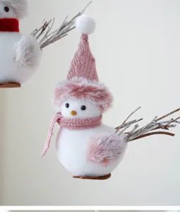 Charming Christmas pink bird hanging ornament with knitted hat and scarf detail closeup view