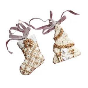 Christmas tree hanging ornaments, resin white and gold stocking and tree decor with ribbons.