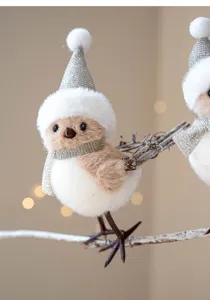 Detailed close-up of cute Christmas bird ornament with glitter hat and scarf for holiday decor.