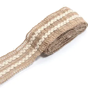 Close-up detail of natural burlap ribbon with white braided lace trim for DIY gift wrapping crafts.