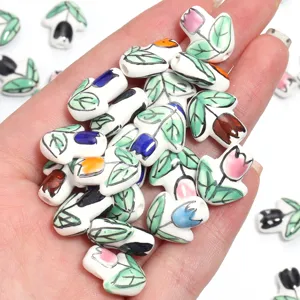 Close-up of colorful ceramic tulip flower beads, handmade DIY jewelry making accessories.
