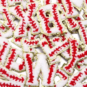 Close-up detail of chenille alphabet patches with baseball stitch and gold glitter edge.
