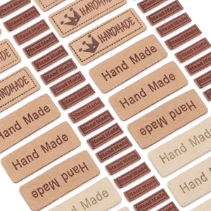 Detailopname van 1.5x4cm microfiber leer handgemaakte reliëf labels voor DIY tassen en kleding.