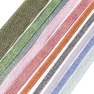 Detailed view of colorful metallic glitter ribbons, sparkling fabric trim for DIY crafts.