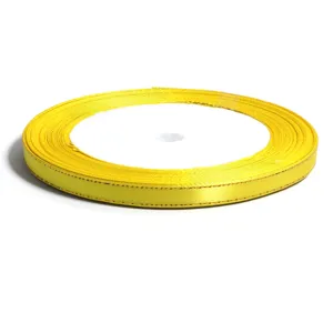 Yellow gold edge ribbon roll detail view, perfect for gift wrapping and DIY crafts.