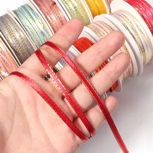 Detail shot of red metallic gold-edged polyester ribbon for gift wrapping, baking and DIY crafts.