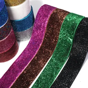Close-up detail of colorful glitter velvet ribbons, sparkly fabric trim for DIY crafts.