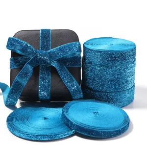 Blue glitter ribbon rolls and bow detail for DIY clothing, bags, and party gift box decoration.
