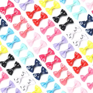 Close up of colorful ribbon bows with cute heart prints, ideal for DIY hair accessories.