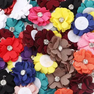 Colorful fabric flower DIY accessories with rhinestone centers and felt backing for crafts.