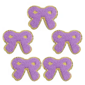 Toppe con fiocco ricamato in spugna con bordo dorato per accessori di vestiti e borse.