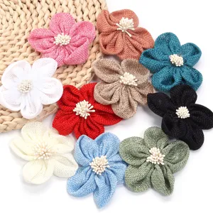 Handmade burlap five petal fabric flowers with stamen details, ideal for DIY crafts and accessories.