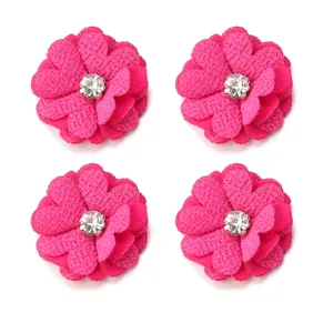 Close-up detail of hot pink fabric DIY flowers featuring sparkling crystal rhinestone centers.