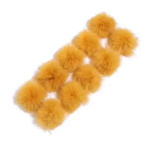 Detail shot of yellow fluffy fur pom-poms on backing card, perfect for DIY crafts and accessories.