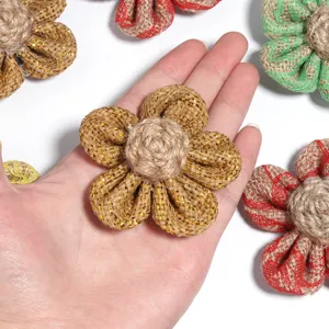 Close-up detail shot of handmade burlap flower accessory in hand, perfect for DIY crafts and decor.