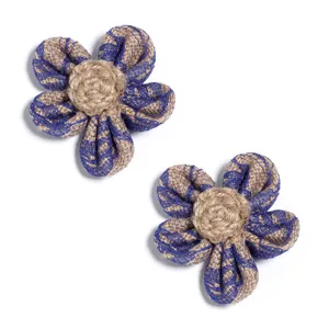 Detailed close-up view of handmade burlap five-petal flower with mesh and woven pistil.