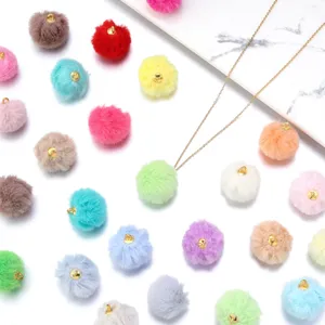 Colorful faux fur pom pom pendants with gold loops, perfect for DIY jewelry and crafts.