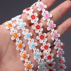 Close-up detail of polyester embroidered daisy lace trim showcasing colorful flower centers.