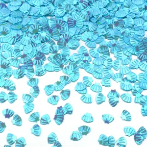 Primo piano di paillettes a conchiglia blu brillanti, perfette per nail art e accessori fai-da-te.