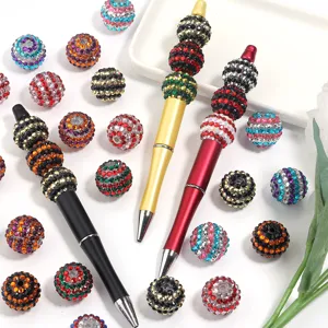 Handmade DIY rhinestone beaded pens and colorful resin drill balls for crafts and accessories details.