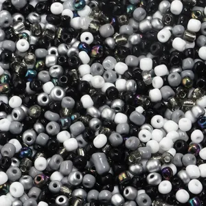 Close up detail view of mixed monochrome and iridescent glass seed beads for crafts.