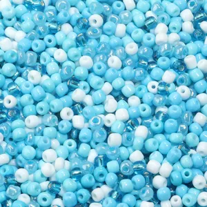 Close-up view of vibrant blue and white glass seed beads, perfect for DIY jewelry crafting.