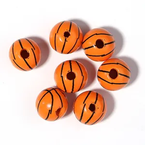 Close-up of wooden basketball beads, orange painted sphere with black lines, DIY craft detail.