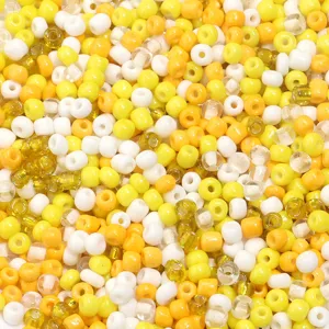 Colorful glass seed beads detail, vibrant yellow and white mix for jewelry DIY and slime.