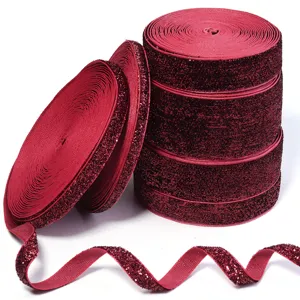 Glitter velvet ribbon close-up, sparkling red fabric trim for DIY crafts and gift wrapping.