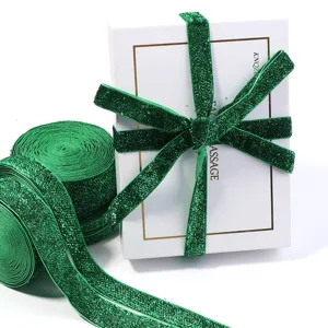 Green glitter velvet ribbon detail view, sparkling gift wrapping trim for festive decor and crafts.