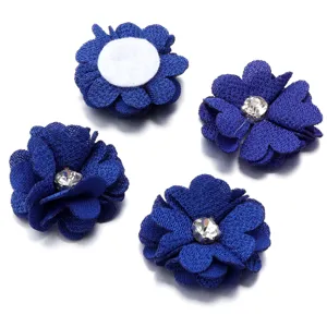 Close-up of royal blue fabric flower with sparkling rhinestone center and backing pad view