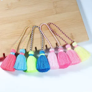 Colorful mini tassels decorative pendants with braided hanging loops for crafts clothing decor.