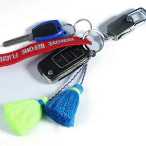 Detailed close-up view of the double-ended tassel keychain charm featuring vibrant neon and blue colors.