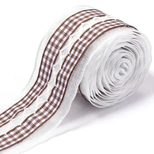 Close-up detail of white sheer lace ribbon with brown checkered edge for gift wrapping.