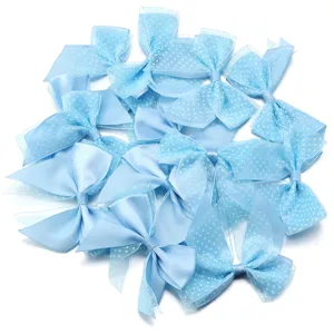 Close-up detail of light blue polka dot mesh double-layer bow DIY accessory material.