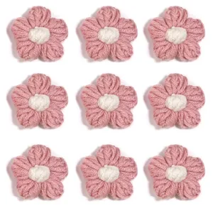 Close-up detail of handmade crochet pink wool flower accessories, soft texture for DIY decor.